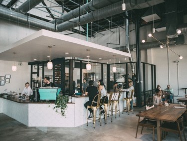 Interior of East Pole Coffee with people seated around the bar and at tables