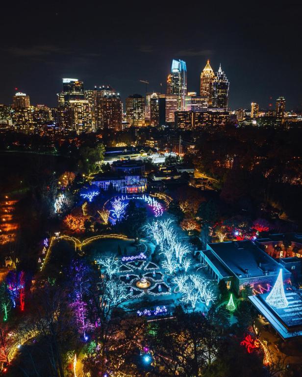Aerial view of holiday lights at night in a city.