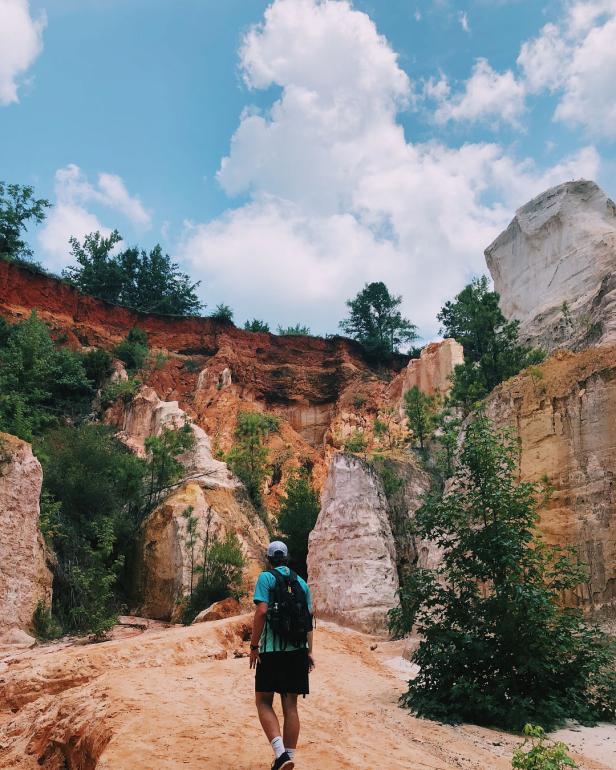 Man hiking in Providence Canyon State Park in Lumpkin, Georgia