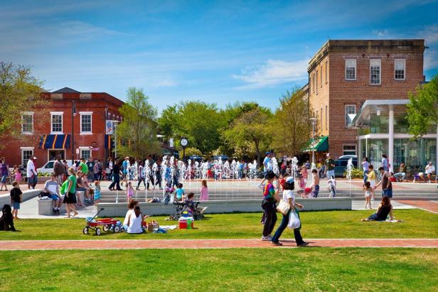 A crowd mingles around a fountain at City Market in Savannah
