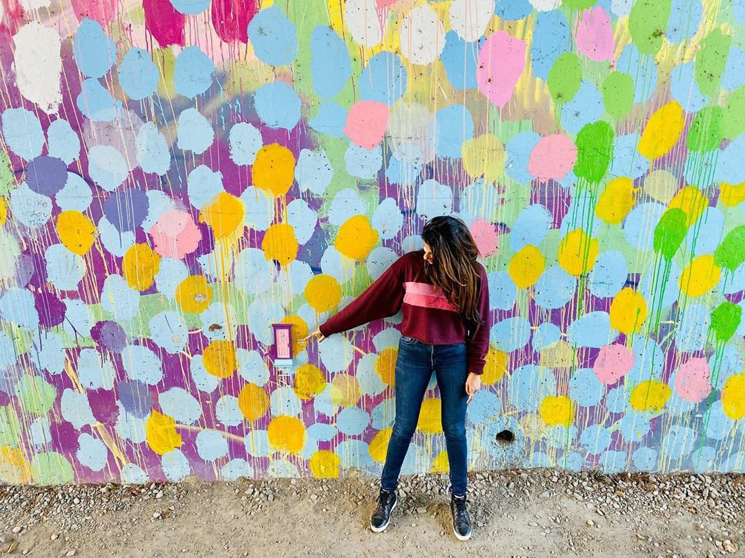 Woman at a mural on the Atlanta BeltLine. Photo by @nomasaurus21