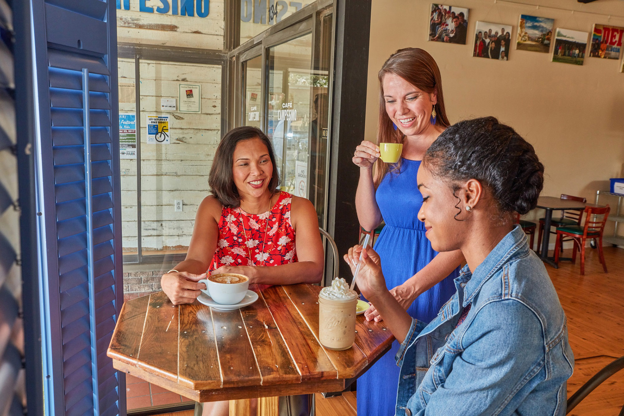Three women enjoy coffee at Cafe Campesino in Americus, Georgia