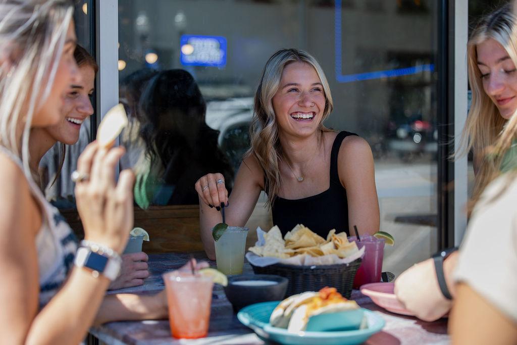 Group of women at restaurant enjoying tacos