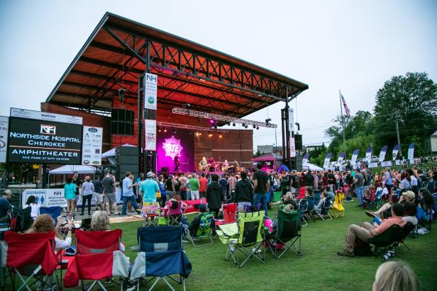 people sitting on a lawn watching a Better than Ezra concert