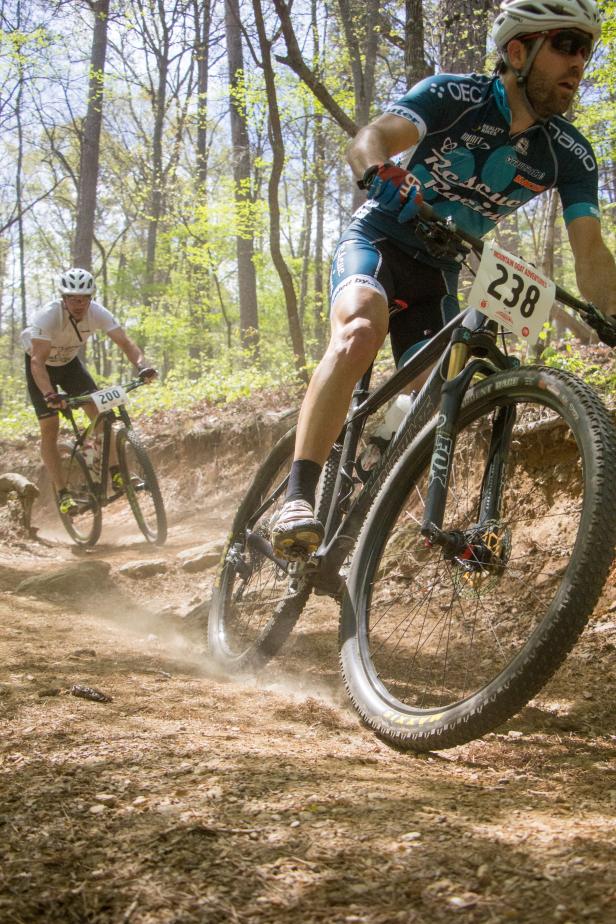 2 men compete in biking on trail - photo by Dashing Images