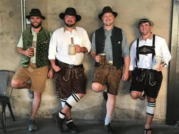 Four men in traditional clothing at Oktoberfest at Georgia Beer Co. in Valdosta, Georgia