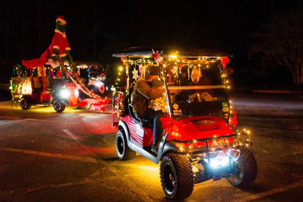 golf cards lit up in Christmas lights for parade