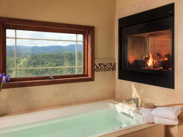Tub and fireplace with a mountain view at Lucille's Mountain Top Inn & Spa