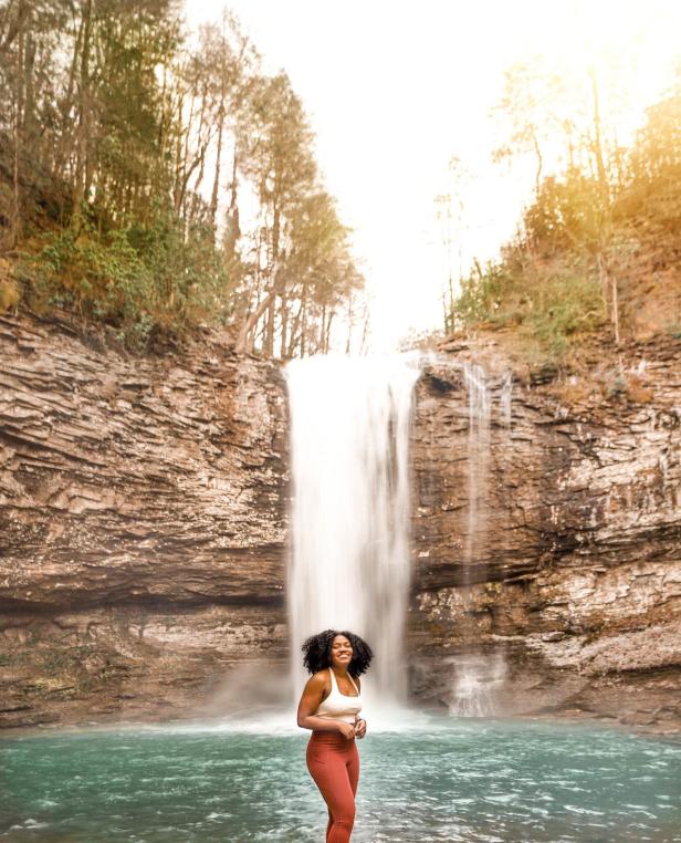 Woman in front of a waterfall at Cloudland Canyon State Park in Rising Fawn, Georgia. Photo by @asipoftee