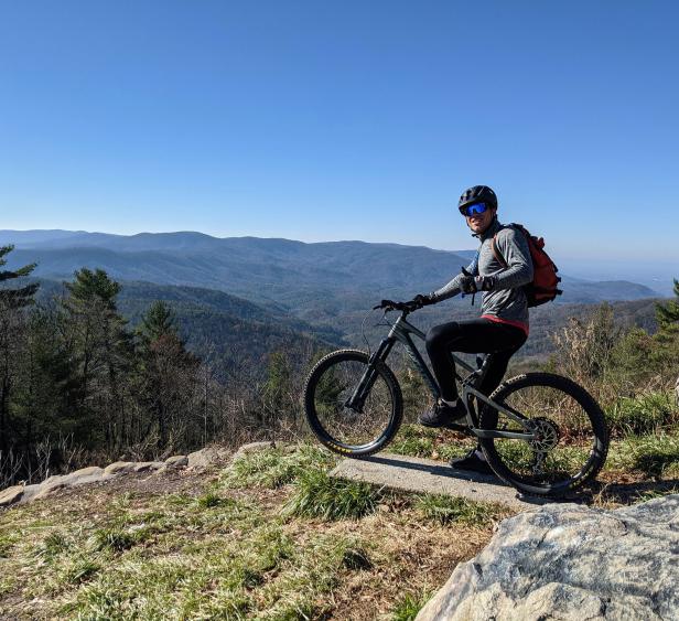 A cyclist overlooking mountains in Ellijay, Georgia. Photo by @rickyvandevall