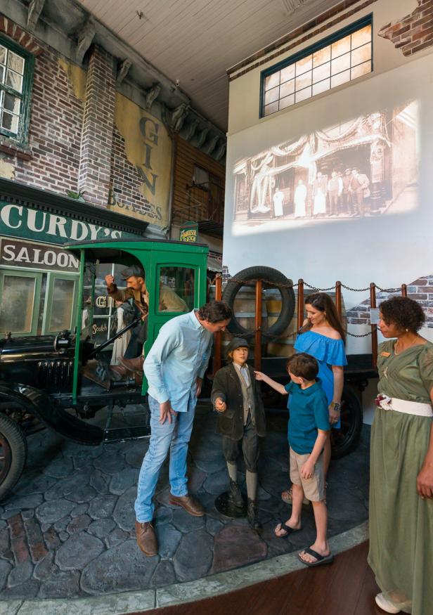 Family looking at an exhibit at the American Prohibition Museum in Savannah, Georgia