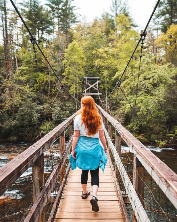 Woman on the Toccoa River Swinging Bridge in Blue Ridge, Georgia