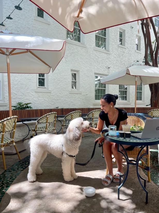 Woman and dog in the courtyard at Hotel Granada