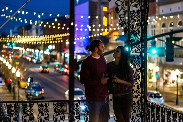 Couple on a balcony at night at The Marshall House in Savannah