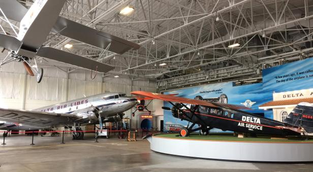 Two planes facing each other inside a bay at the Delta Flight Museum in Atlanta, Georgia