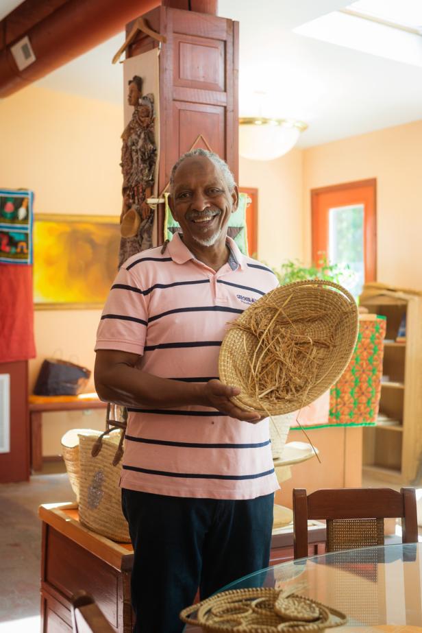 Man shows a handmade basket at the Geechee Kunda Cultural Center in Riceboro, Georgia