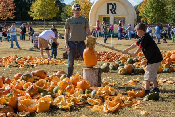 A boy smashes pumpkins at Pumpkin Destruction Day at The Rock Ranch in The Rock, Georgia