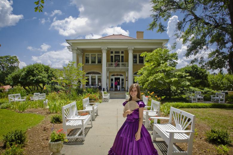 A model stands in an Antebellum-era dress outside the Blue Willow Inn in Social Circle, Georgia
