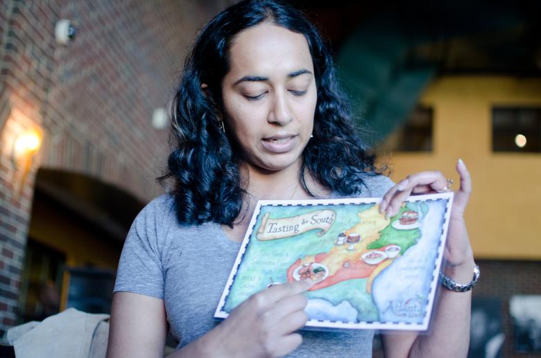 An Atlanta Food Walks tour guide points out locations on a map