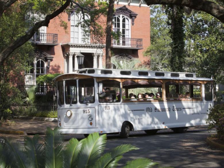 Old Savannah Tours trolley by the Mercer Williams House